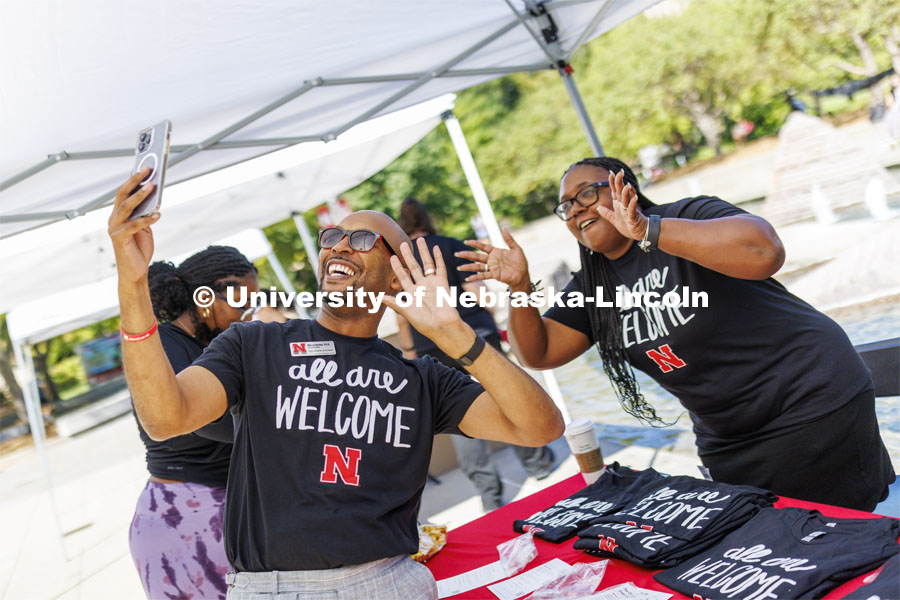 Marco Barker and Charlie Foster wave to the camera as Marco livestreams the event on Facebook. ODI at the Union Plaza with activities, treats, and to learn more about the Office of Diversity and Inclusion. August 30, 2022. Photo by Craig Chandler / University Communication.