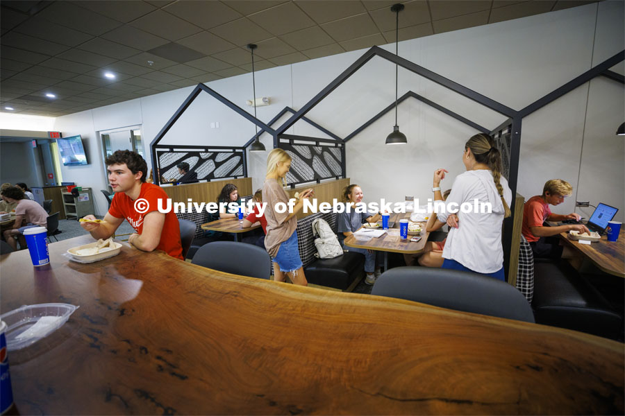 Livi Swanson, a freshman from Lincoln, talks with friends as she eats in one of the new seating areas in Selleck Dining Hall. The area has been turned into a food court with new seating areas. August 30, 2022. Photo by Craig Chandler / University Communication.