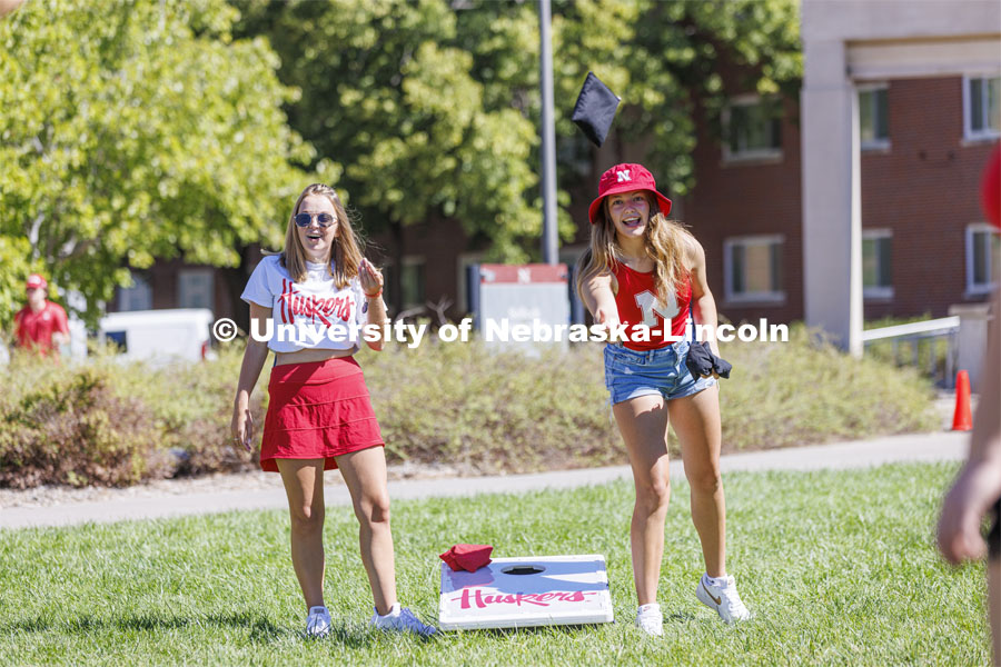 Tenley Simmons, a sophomore from Minneapolis, Minnesota, right, and Kate Aleknavicius, a sophomore from Milkwaukee, Wisconsin, compete in Corn Hole at the Student Tailgate and Unity Walk in the Union green space before the game. NU vs. North Dakota. September 3, 2022. Photo by Craig Chandler / University Communication.