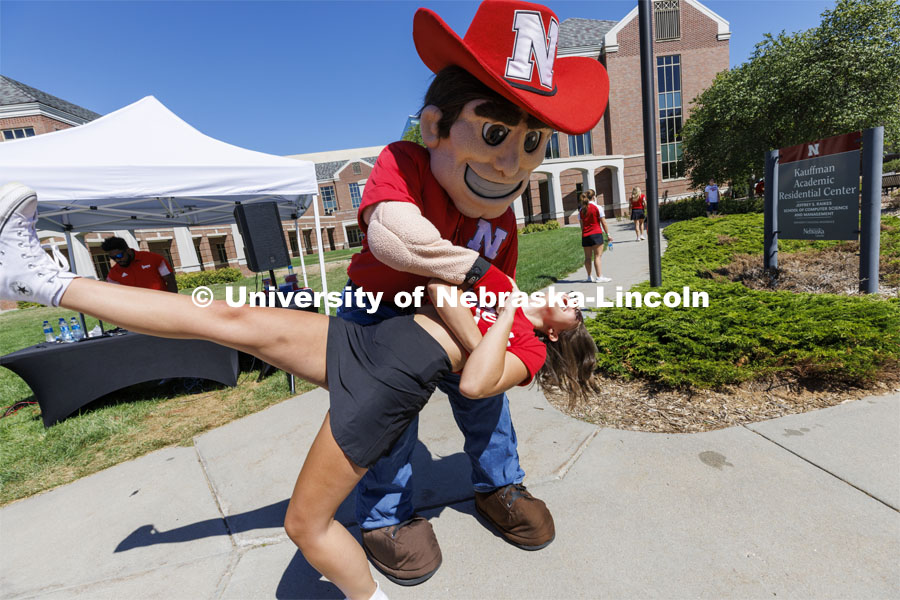 Herbie Husker dips Delanie Ferzely, a sophomore from Omaha, as they dance at the Student Tailgate and Unity Walk in the Union green space before the game. NU vs. North Dakota. September 3, 2022. Photo by Craig Chandler / University Communication.