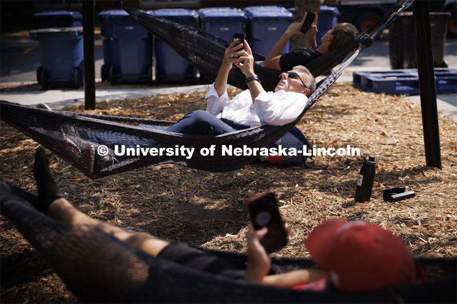 Chancellor Ronnie Green grabs a few minutes of calm in the hammocks at the Nebraska Union Plaza. September 7, 2022. Photo by Craig Chandler / University Communication.
