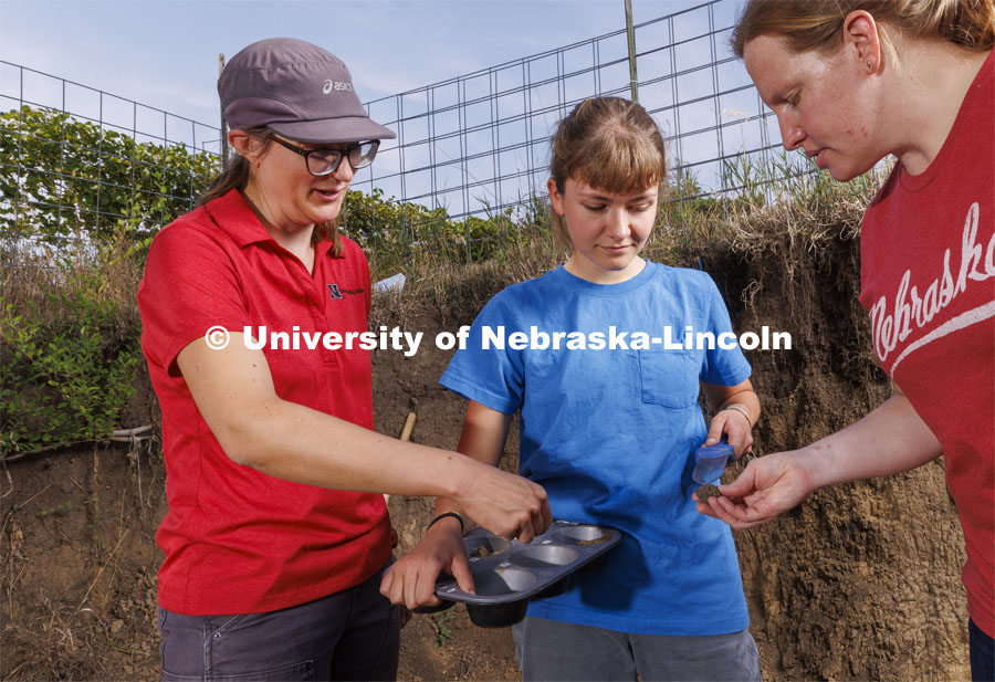 Kennadi Griffis examines a sample with her coaches, Judith Turk, left, and Becky Young in the pit on East Campus. Griffis’ curiosity about the natural environment and the opportunities she found at the University of Nebraska–Lincoln propelled the Husker to an international championship in soil judging as a member of Team USA. September 9, 2022. Photo by Craig Chandler / University Communication.