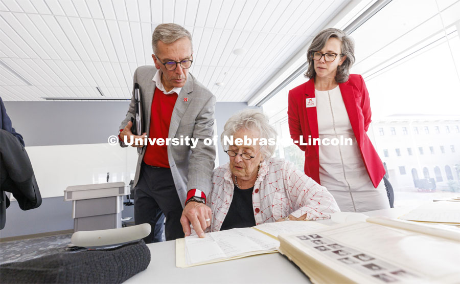 Ruth Scott looks over correspondence from George Beadle that reside in the UNL Library Special Collections. Chancellor Ronnie Green points out a name as Universities Libraries Claire Stewart looks on. Bill and Ruth Scott were honored at the dedication of the George Beadle statue at the Dinsdale Learning Commons on East Campus. September 13, 2022. Photo by Craig Chandler / University Communication.