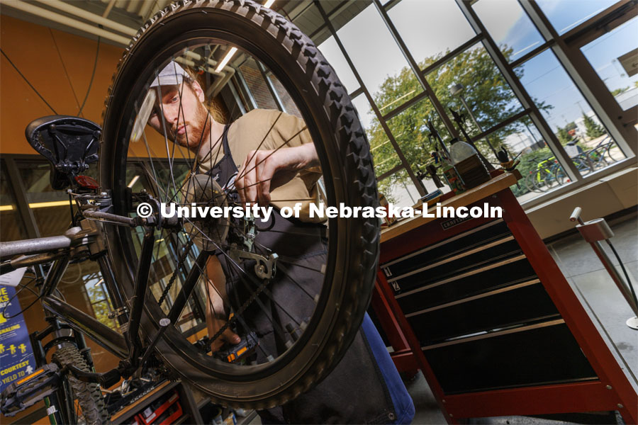Drew Roper, a junior from Omaha, works as a bike mechanic in the shop. Outdoor Adventures Bike Shop located in the Outdoor Adventures Center on City Campus. September 15, 2022. Photo by Craig Chandler / University Communication.
