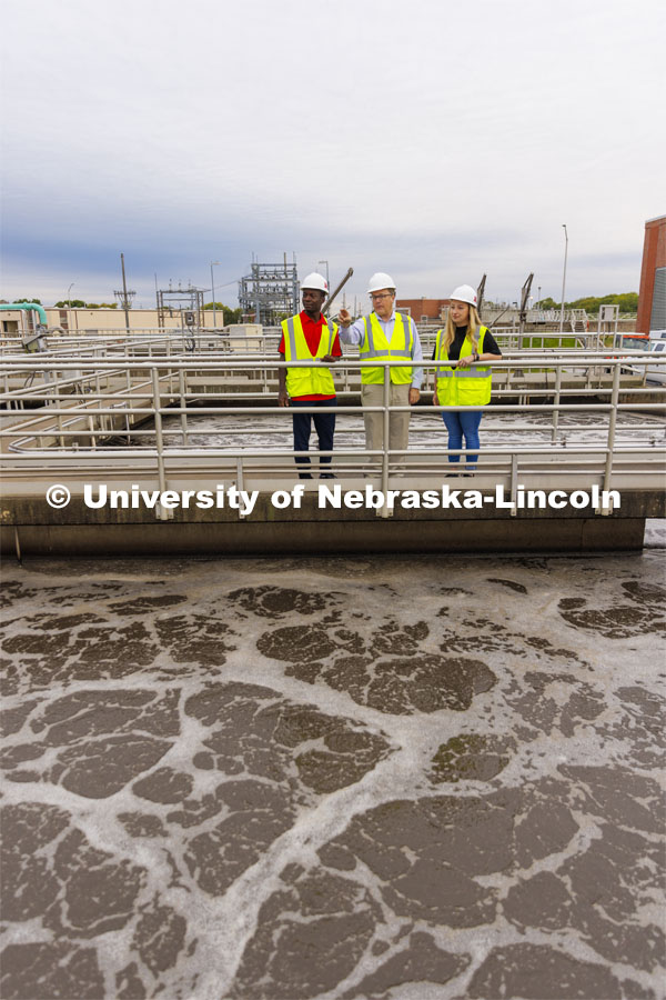 Bruce Dvorak, center, Professor of Civil and Environmental Engineering, discusses the sedimentation tanks with Yves Cedric Tamwo Noubissi, left, senior in Mechanical Engineering, center and Sussan Moussavi, graduate student in Civil Engineering at Lincoln’s Wastewater Treatment Plant northeast of Innovation Campus. September 23, 2022. Photo by Craig Chandler / University Communication.