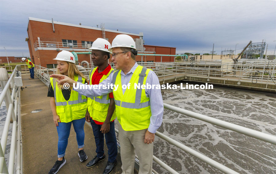 Bruce Dvorak, right, Professor of Civil and Environmental Engineering, discusses the sedimentation tanks with Yves Cedric Tamwo Noubissi, senior in Mechanical Engineering, center and Sussan Moussavi, graduate student in Civil Engineering at Lincoln’s Wastewater Treatment Plant northeast of Innovation Campus. September 23, 2022. Photo by Craig Chandler / University Communication.
