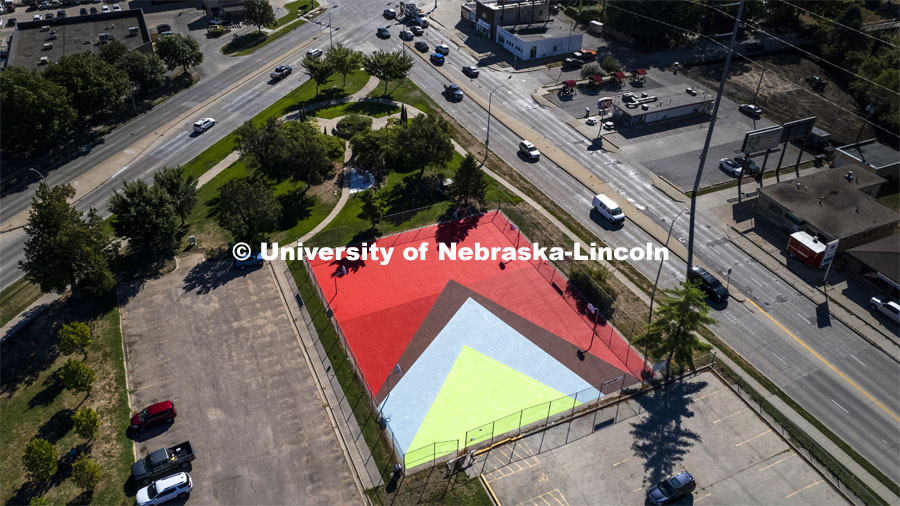 Two South Antelope Park basketball courts have been painted into a giant mural. The mural design is based on a painting by African American artist Felrath Hines, entitled “Red Sea” created in 1985. The original painting is in the permanent collection of the Sheldon Art Museum. Hines (1913-1993) was a prolific expressionist and later geometric abstract painter based in New York and Washington, DC. September 26, 2022. Photo by Craig Chandler / University Communication.