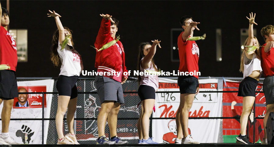 Members of Triad 2 (Delta Upsilon, Gamma Phi Beta and Pi Kappa Alpha) mike drop their ears of corn at the end of their performance. Showtime at the Vine Street Fields. Recognized Student Organizations, Greeks and Residence Halls battle against each other with performances for Homecoming competition points and ultimate bragging rights. Homecoming 2022. September 26, 2022. Photo by Craig Chandler / University Communication.