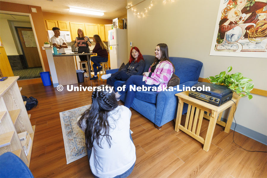 Students socializing in an apartment style room in The Courtyards Residence Hall. Housing Photo Shoot in The Courtyards Residence Hall. September 27, 2022. Photo by Craig Chandler / University Communication.