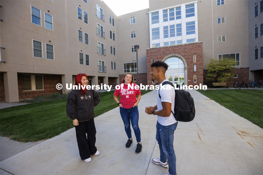 Students socialize outside the Courtyards Residence Hall. Housing Photo Shoot in The Courtyards Residence Hall. September 27, 2022. Photo by Craig Chandler / University Communication.