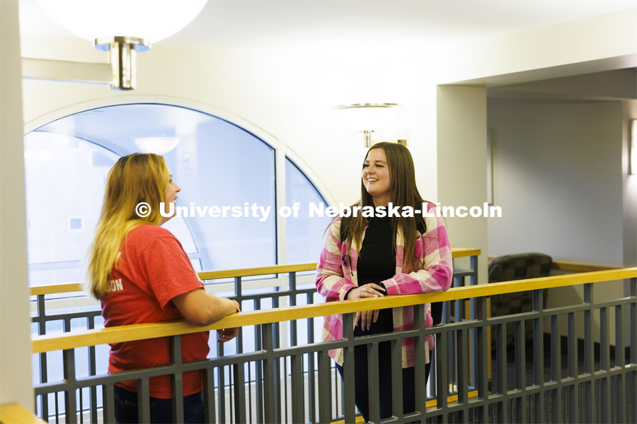 Two students stop to visit on a walkway in the Courtyards Residence Hall. Housing Photo Shoot in The Courtyards Residence Hall. September 27, 2022. Photo by Craig Chandler / University Communication.