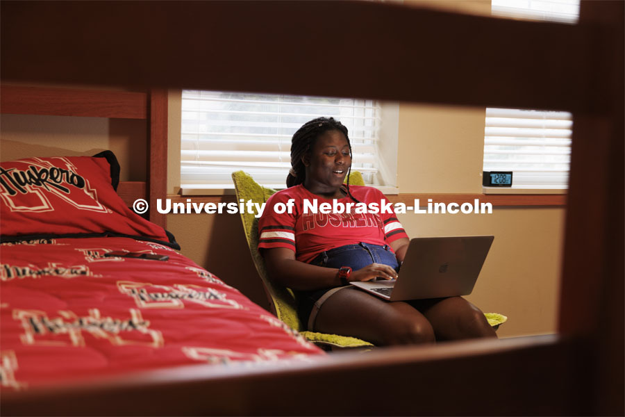 A student uses her laptop to study in her University Suites Residence Hall room. Housing Photo Shoot in University Suites Residence Hall. September 27, 2022. Photo by Craig Chandler / University Communication.