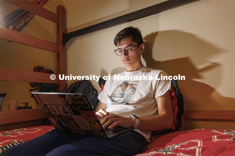 A student uses their laptop to study in their University Suites Residence Hall room. Housing Photo Shoot in University Suites Residence Hall. September 27, 2022. Photo by Craig Chandler / University Communication.