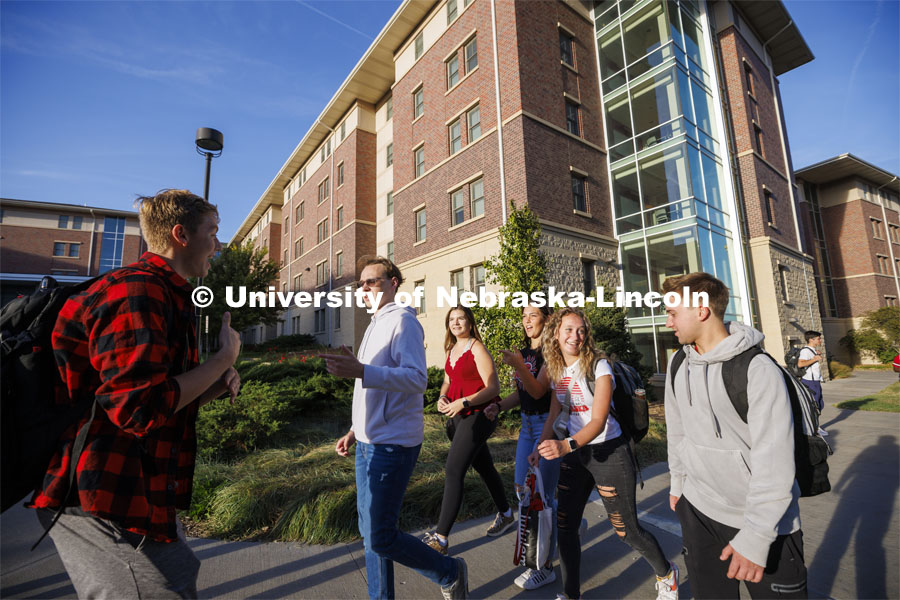 Students leaving University Suites Residence Hall to get to their classes. Housing Photo Shoot in University Suites Residence Hall. September 27, 2022. Photo by Craig Chandler / University Communication.