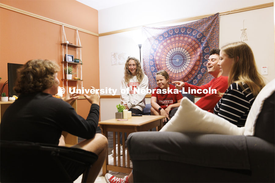 Students socializing in a University Suites Residence Hall room. Housing Photo Shoot in University Suites Residence Hall. September 27, 2022. Photo by Craig Chandler / University Communication.