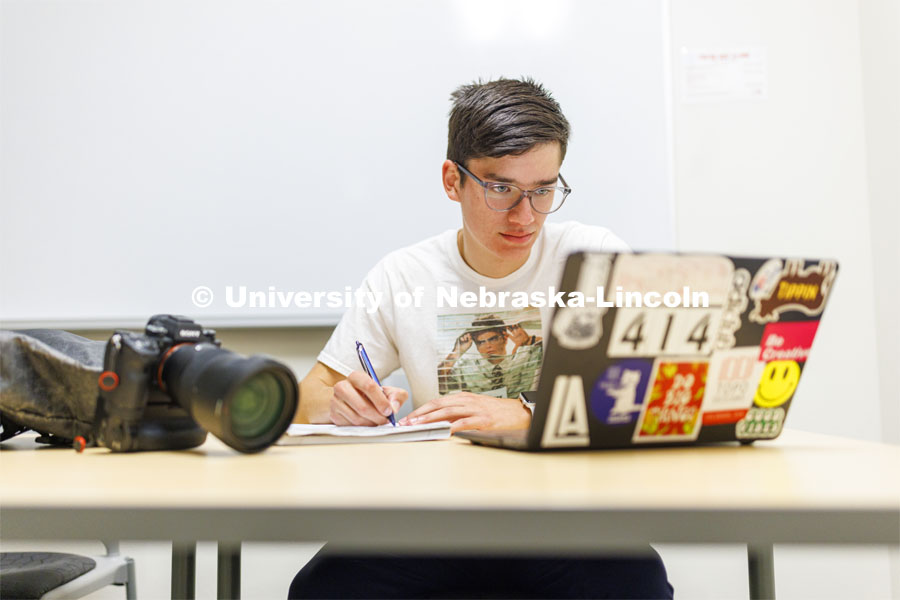 One student studying in a commons area in University Suites Residence Hall. Housing Photo Shoot in University Suites Residence Hall. September 27, 2022. Photo by Craig Chandler / University Communication.