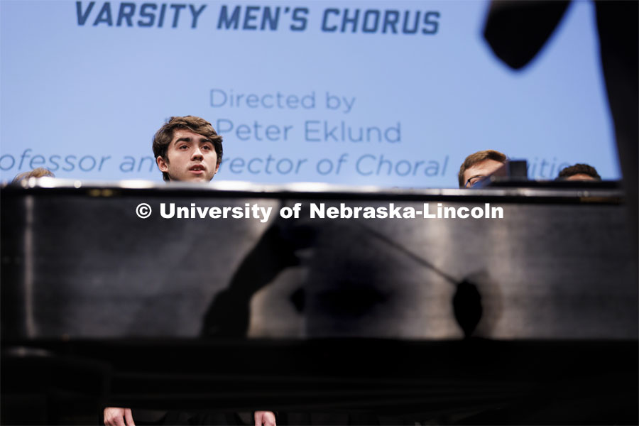 Peter Eklund’s shadow falls on the side of the piano as he directs the Varsity Men’s Chorus to open the 2022 State of Our University address. September 28, 2022. Photo by Craig Chandler / University Communication.