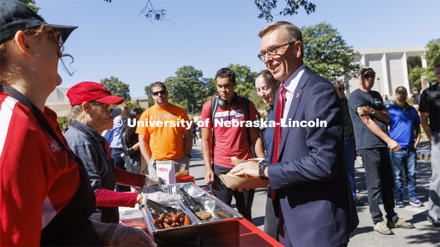 Chancellor Ronnie Green smiles as he works his way through the food line on R Street for the all-employee picnic. The picnic followed the Chancellor’s 2022 State of Our University address. September 28, 2022. Photo by Craig Chandler / University Communication.