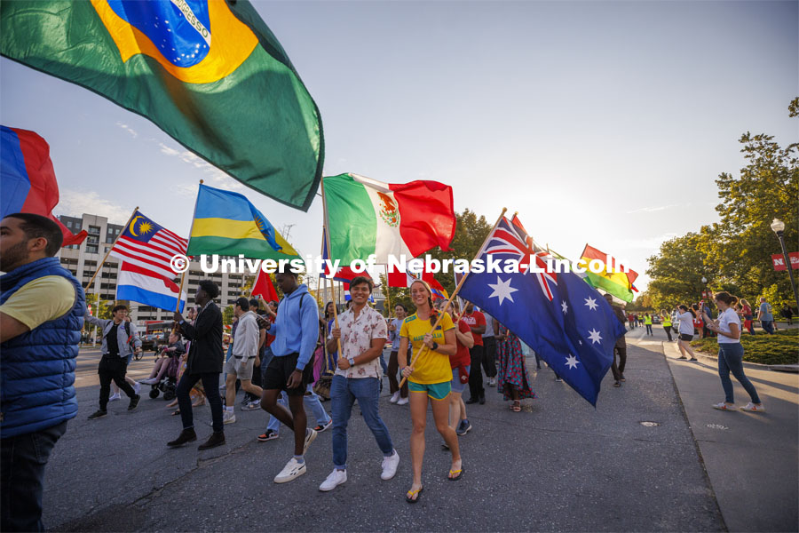 International students carry their flags in the Homecoming Parade and Cornstalk. September 30, 2022. Photo by Craig Chandler / University Communication.