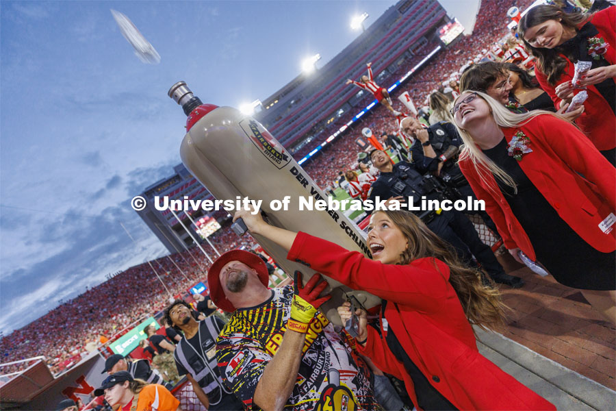 Soon-to-be-crowned homecoming royalty Emily Hatterman fires a hot dog into the crowd from Der Viener Schlinger as each of the homecoming candidates took a turn on the schlinger. Homecoming game. Nebraska football vs. Indiana.  October 1, 2022. Photo by Craig Chandler / University Communication. 
