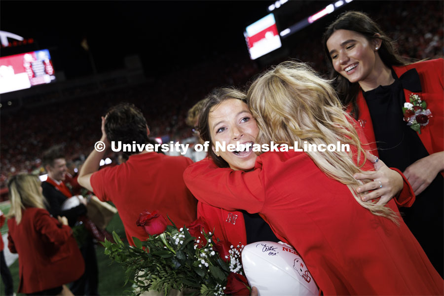 Newly crowned homecoming royalty Emily Hatterman gets a hug as she leaves the field. Nebraska vs. Indiana football Homecoming game. October 1, 2022. Photo by Craig Chandler / University Communication.