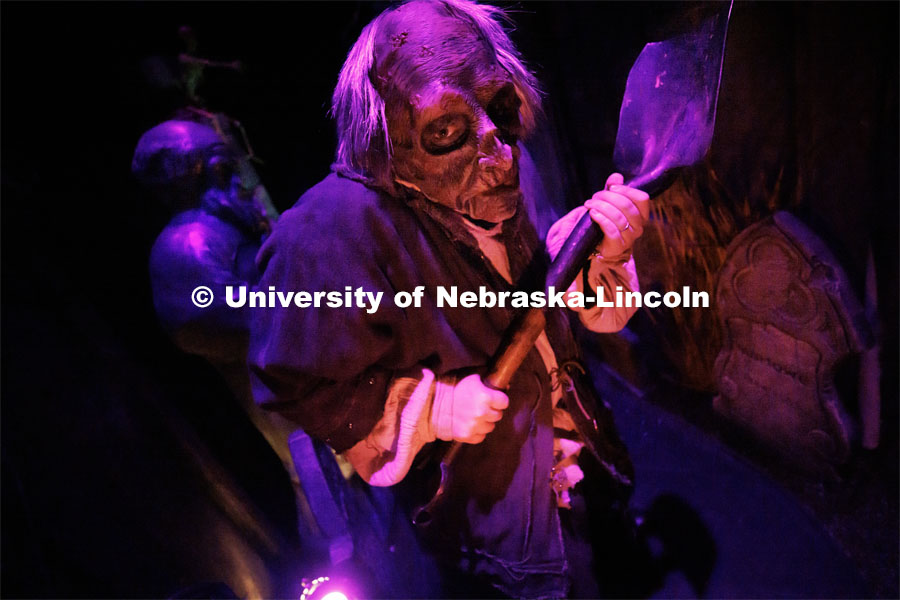 Jackson Wells performs as the Gravedigger as he awaits the next group to scare on a recent Friday evening. ShakesFear production in the Temple Building. October 21, 2022. Photo by Craig Chandler / University Communication.