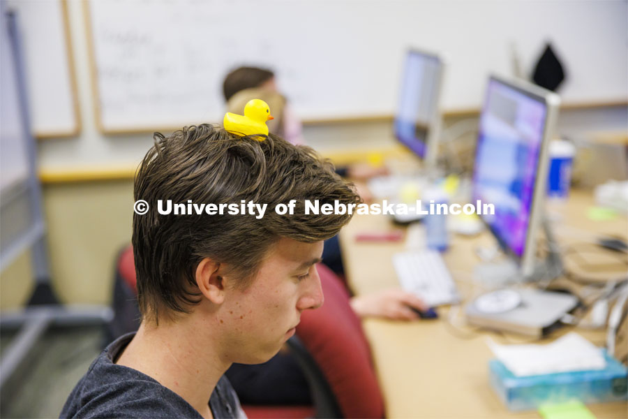 Student with a rubber duckie on his head. Students working in a classroom. Raikes School photo shoot. October 27, 2022. Photo by Craig Chandler / University Communication. 