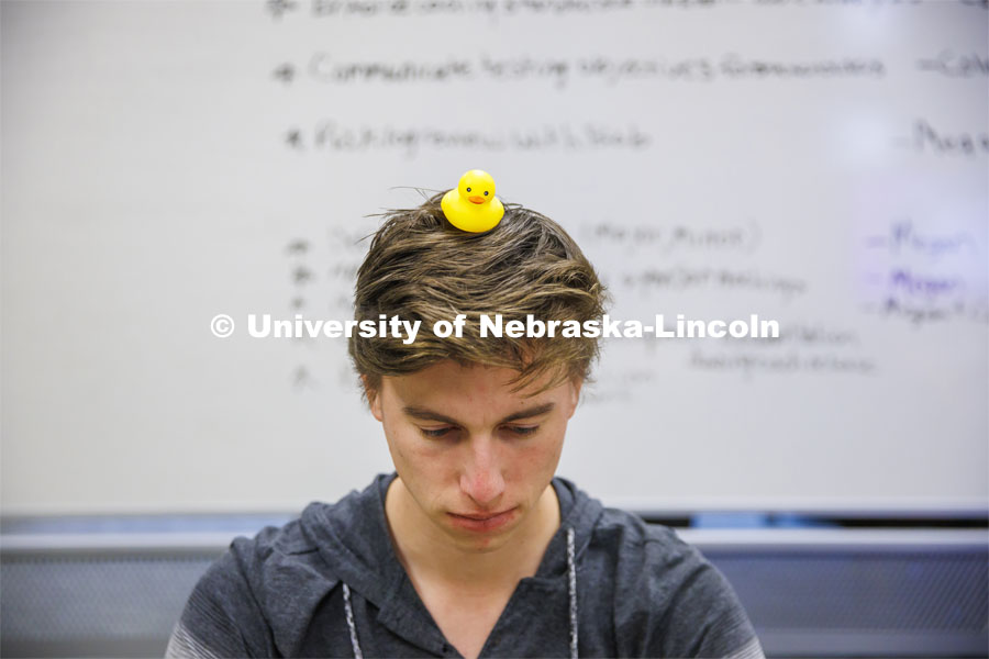 Student with a rubber duckie on his head. Students working in a classroom. Raikes School photo shoot. October 27, 2022. Photo by Craig Chandler / University Communication. 