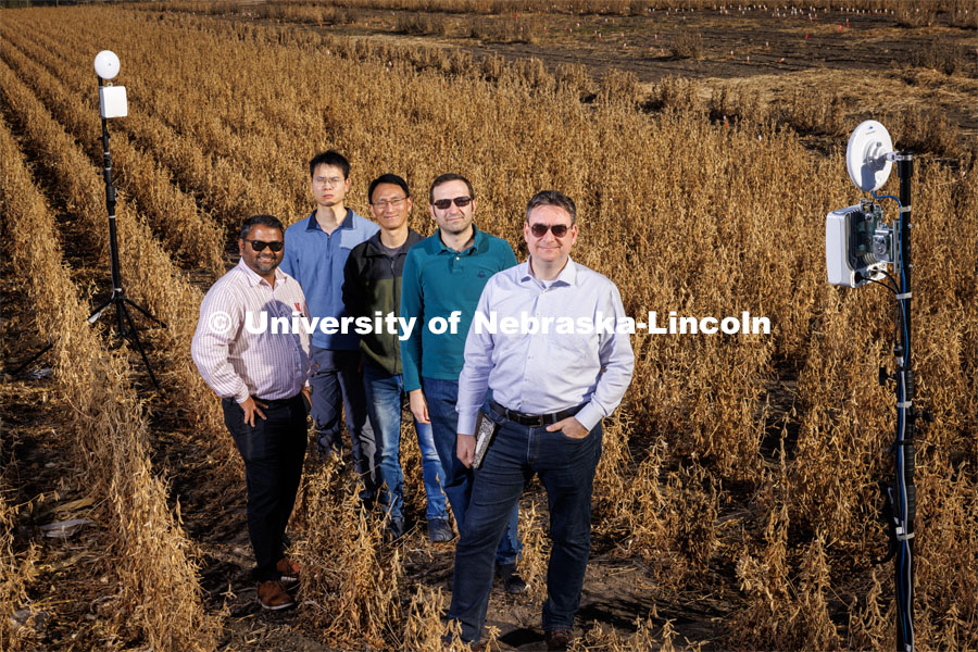 Members of the Field-Nets research team pose in a soybean field on east campus field with their Millimeter-wave (mmWave) radios with phased-array antennas. The researchers (from left) are Santosh Pitla, Qiang Liu, Yufeng Ge, Christos Argyropoulos and Mehmet Can Vuran. October 28, 2022. Photo by Craig Chandler / University Communication.