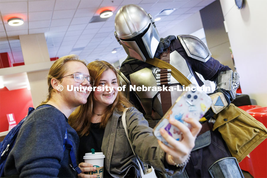 Sam Pharris, a freshman from Aberdeen, South Dakota, and Violet Curran, a freshman from Philadelphia, pose with the Mandalorian in the Nebraska Union. Halloween on City Campus. October 31, 2022. Photo by Craig Chandler / University Communication.