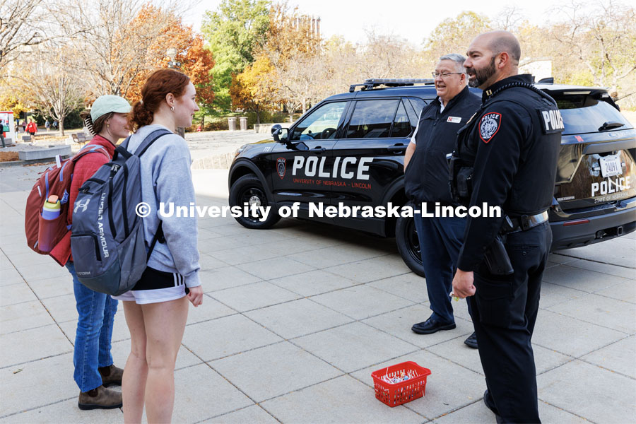 Captain Aaron Pembleton, right, and Marty Fehringer, Assistant Chief of Police, talk with students about the new color scheme for UNL Police Department cruisers. UNL Police Department displays their new cruiser in the new all-black paint scheme at the Nebraska Union Plaza. November 2, 2022. Photo by Craig Chandler / University Communication.