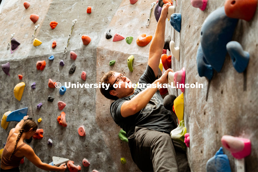 Students climb a boulder route during the League of Extraordinary Boulderers. League of Extraordinary Boulderers scale the climbing wall at Campus Recreation’s Outdoor Adventure Center. November 3, 2022. Photo by Jonah Tran / University Communication.