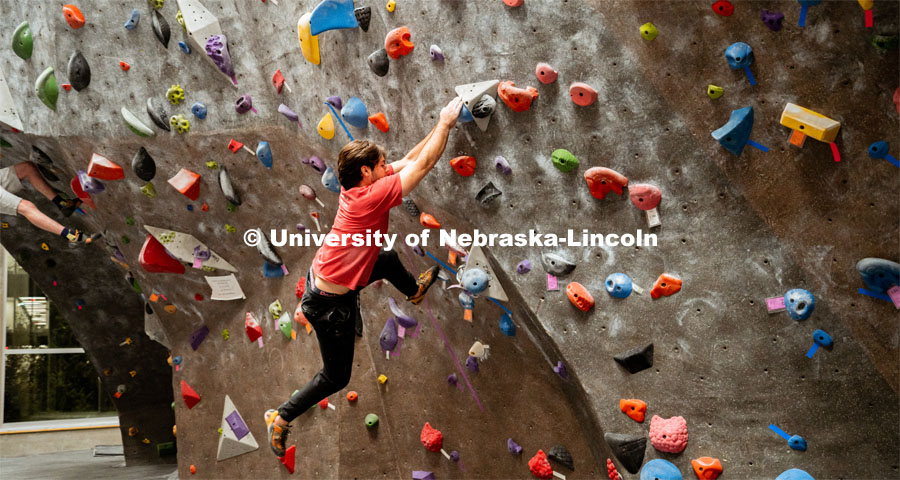 Students climb a boulder route during the League of Extraordinary Boulderers. League of Extraordinary Boulderers scale the climbing wall at Campus Recreation’s Outdoor Adventure Center. November 3, 2022. Photo by Jonah Tran / University Communication.