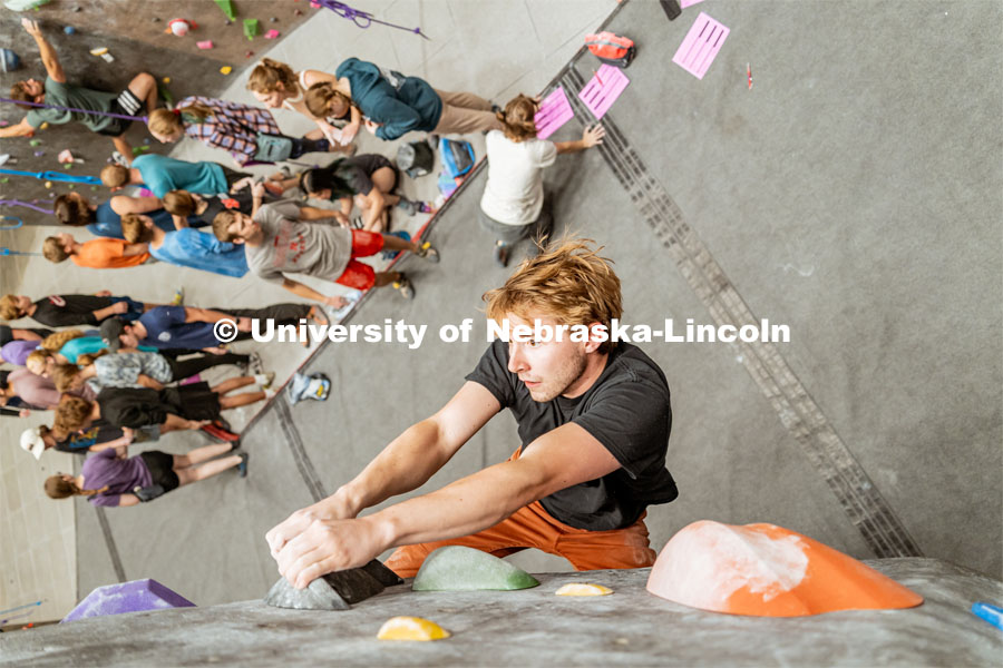 Bryce May, UNL Alumni, climbing a boulder route during the League of Extraordinary Boulderers. League of Extraordinary Boulderers scale the climbing wall at Campus Recreation’s Outdoor Adventure Center. November 3, 2022. Photo by Jonah Tran / University Communication.