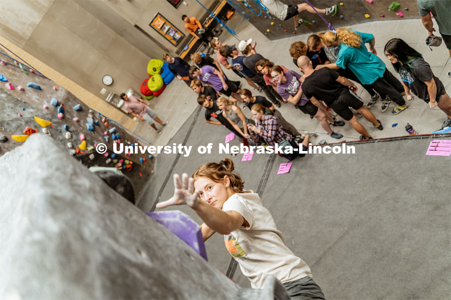 Allison Linton, senior, climbing a boulder route during the League of Extraordinary Boulderers. League of Extraordinary Boulderers scale the climbing wall at Campus Recreation’s Outdoor Adventure Center. November 3, 2022. Photo by Jonah Tran / University Communication.