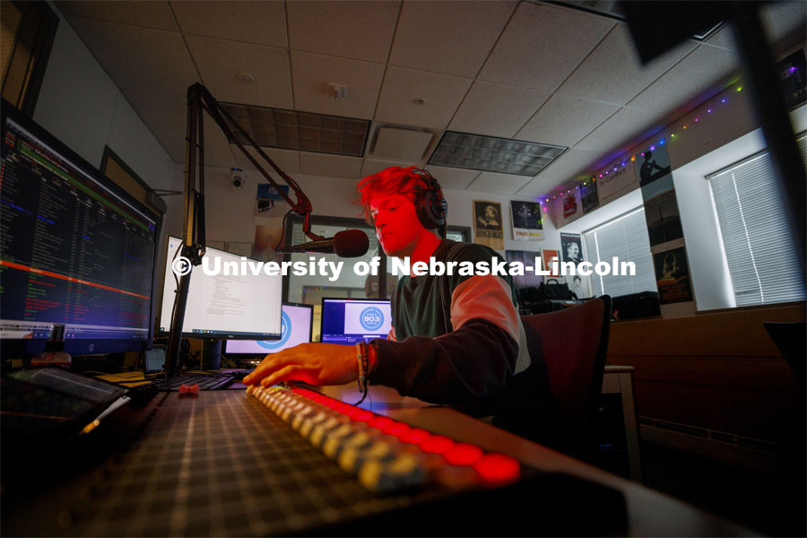 Ryan Luetkemeyer, a sophomore from St. Louis, does the afternoon broadcast from the booth at KRNU. November 9, 2022. Photo by Craig Chandler / University Communication.