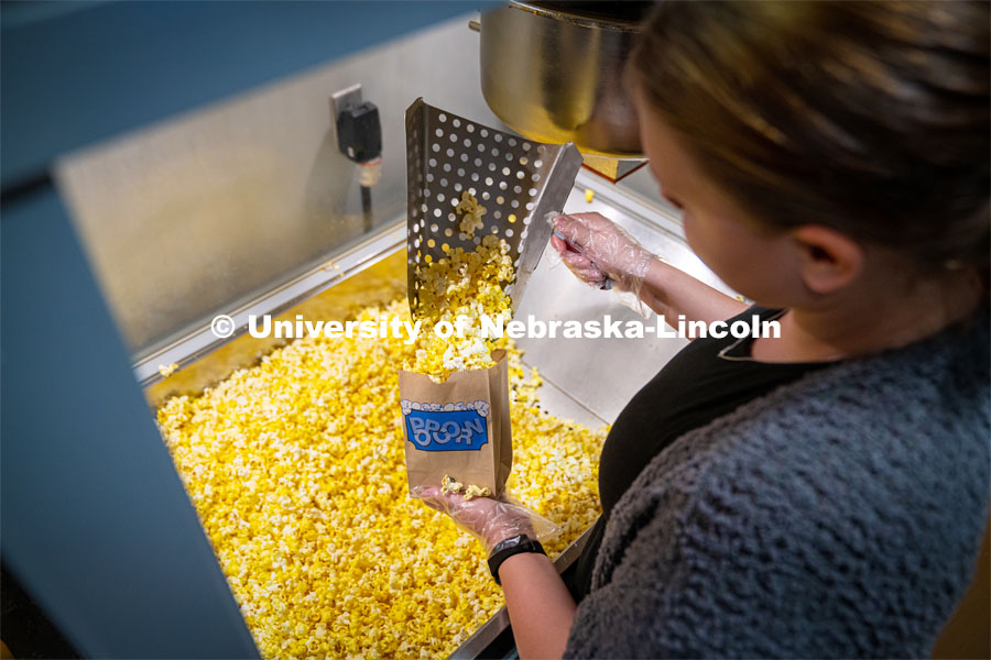 Freshman Emma Georgia helps prepare popcorn for moviegoers at the Ross Theater November 9, 2022. Photo by Dillon Galloway for University Communication