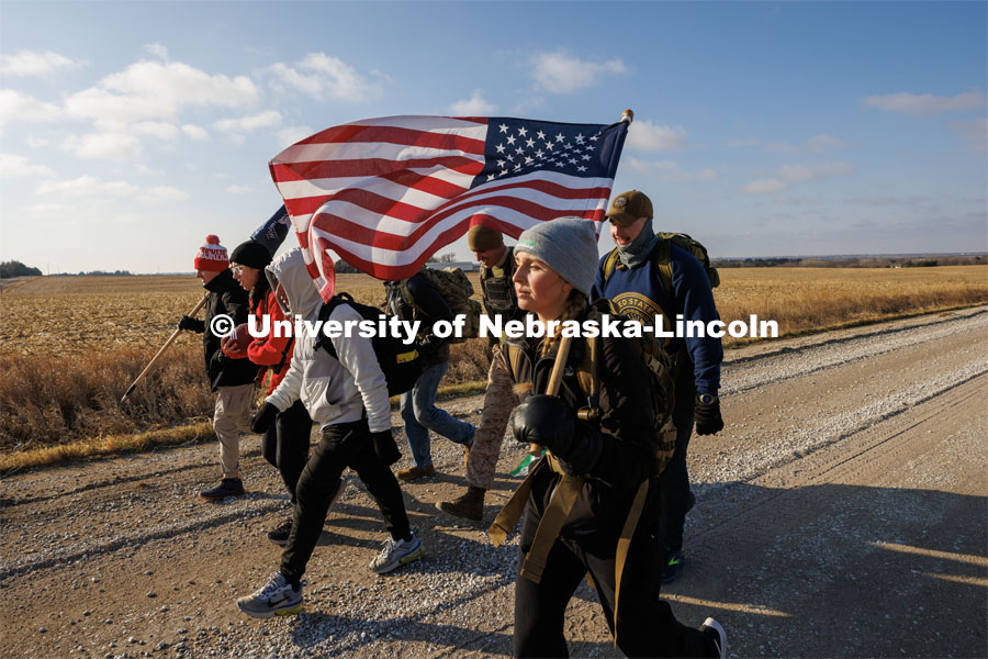 Midshipman Abby Thibodeau and other Ruck Marchers trek along Holdrege Street in rural eastern Lancaster County. Nebraska students and veterans march from Memorial Stadium Wednesday morning. "The Things They Carry" ruck march involving military and veteran students from Iowa and Nebraska. To raise awareness about veteran suicide, through the week, the students walk in 20-mile shifts carrying 20-pound backpacks to commemorate the estimated 20 veterans who die by suicide each day. November 15, 2022. Photo by Craig Chandler / University Communication.