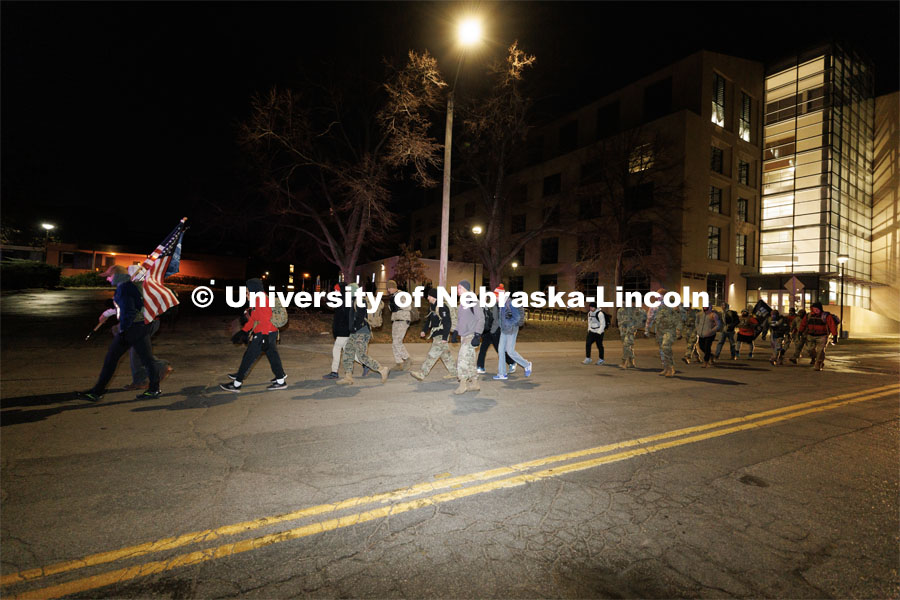 Ruck Marchers begin the march going east through the Veterans Tribute and along Vine street. Nebraska students and veterans march from Memorial Stadium Wednesday morning. "The Things They Carry" ruck march involving military and veteran students from Iowa and Nebraska. To raise awareness about veteran suicide, through the week, the students walk in 20-mile shifts carrying 20-pound backpacks to commemorate the estimated 20 veterans who die by suicide each day. November 15, 2022. Photo by Craig Chandler / University Communication.