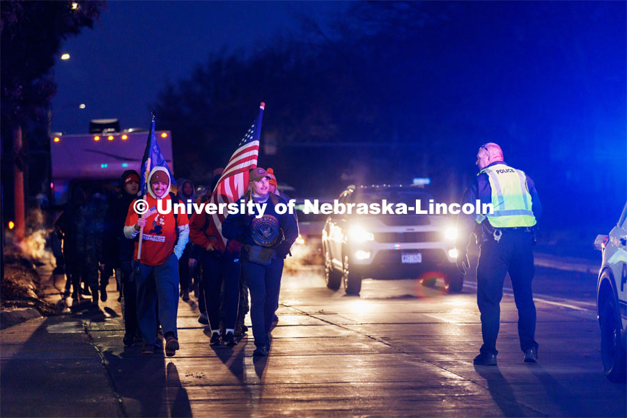 Ruck Marchers begin the march going east through the Veterans Tribute and along Vine street. From left is UNL alumni and veteran Connor Williams and Midshipman Cohan Bonow. Nebraska students and veterans march from Memorial Stadium Wednesday morning. "The Things They Carry" ruck march involving military and veteran students from Iowa and Nebraska. To raise awareness about veteran suicide, through the week, the students walk in 20-mile shifts carrying 20-pound backpacks to commemorate the estimated 20 veterans who die by suicide each day. November 15, 2022. Photo by Craig Chandler / University Communication.