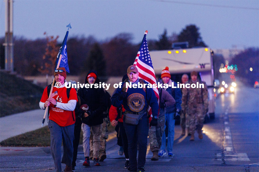 Ruck Marchers begin the march going east through the Veterans Tribute and along Vine street. From left is UNL alumni and veteran Connor Williams and Midshipman Cohan Bonow. Nebraska students and veterans march from Memorial Stadium Wednesday morning. "The Things They Carry" ruck march involving military and veteran students from Iowa and Nebraska. To raise awareness about veteran suicide, through the week, the students walk in 20-mile shifts carrying 20-pound backpacks to commemorate the estimated 20 veterans who die by suicide each day. November 15, 2022. Photo by Craig Chandler / University Communication.