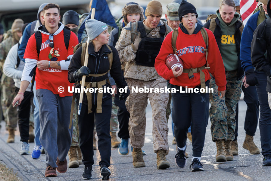 Midshipman Abby Thibodeau and Midshipman Gabrielle Martinez, walk along 84th Street. Nebraska students and veterans march from Memorial Stadium Wednesday morning. "The Things They Carry" ruck march involving military and veteran students from Iowa and Nebraska. To raise awareness about veteran suicide, through the week, the students walk in 20-mile shifts carrying 20-pound backpacks to commemorate the estimated 20 veterans who die by suicide each day. November 15, 2022. Photo by Craig Chandler / University Communication.