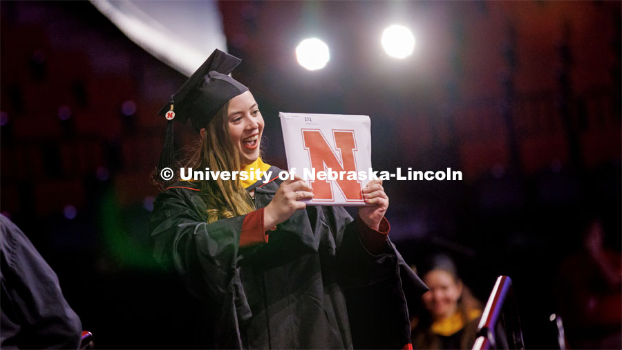 Chloe Chistensen celebrates here masters degree in Food Science and Technology as she walks off stage. Graduate Commencement in Pinnacle Bank Arena. December 16, 2022. Photo by Craig Chandler / University Communication.