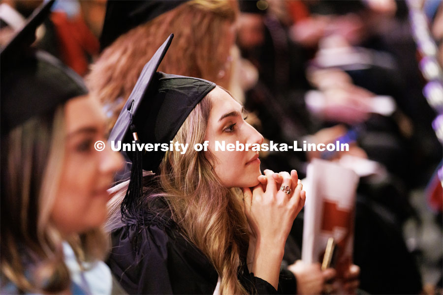 Margarita Shmakova listens to the speakers after receiving her masters degree in Journalism and Mass Communication. Graduate Commencement in Pinnacle Bank Arena. December 16, 2022. Photo by Craig Chandler / University Communication.