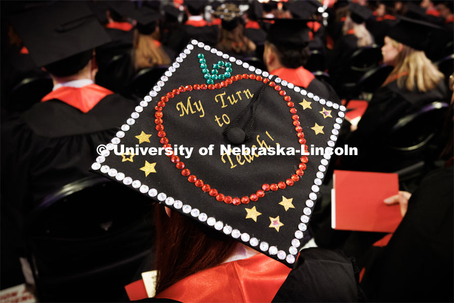 Jade DeRock, a graduate in Elementary Education, decorated her mortar board. Winter Undergraduate Commencement in Pinnacle Bank Arena. December 17, 2022. Photo by Craig Chandler / University Communication.