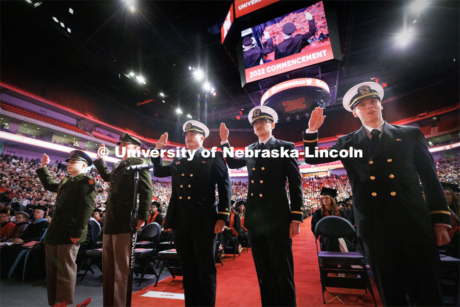 Five Army and Navy ROTC graduates repeat the oath of office at the beginning of commencement. From left are Army Lieutenants Jack O’Dell, Aubrey Fangmeier and Navy Ensigns Cohan Bonow, John Carpenter and Nathan Hills. Winter Undergraduate Commencement in Pinnacle Bank Arena. December 17, 2022. Photo by Craig Chandler / University Communication.