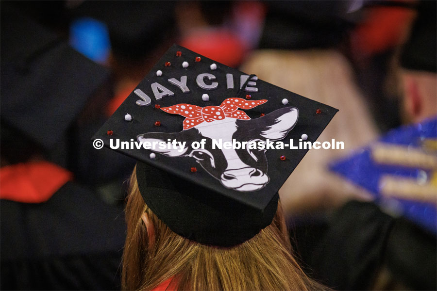 Agribusiness graduate Jaycie Meggison decorated her moo-ving mortar board. Winter Undergraduate Commencement in Pinnacle Bank Arena. December 17, 2022. Photo by Craig Chandler / University Communication.