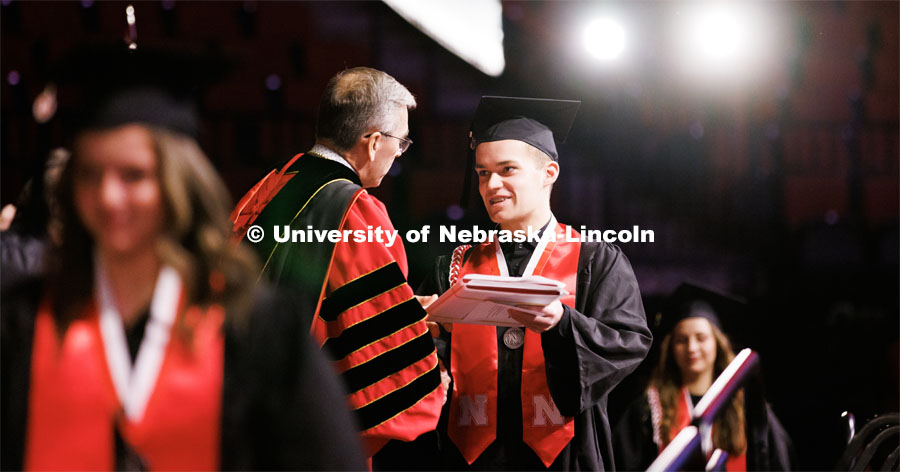 Chancellor Scholar and Elementary Education graduate Brett Foster receives his diplomas from Chancellor Ronnie Green. Winter Undergraduate Commencement in Pinnacle Bank Arena. December 17, 2022. Photo by Craig Chandler / University Communication.