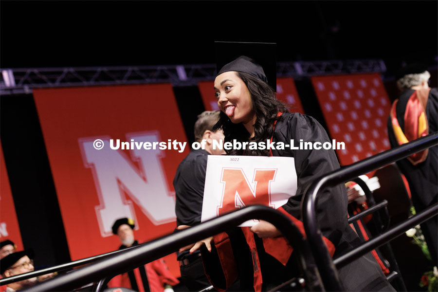 Virginia Mah sticks her tongue out at the Husker Vision cameras. Winter Undergraduate Commencement in Pinnacle Bank Arena. December 17, 2022. Photo by Craig Chandler / University Communication.