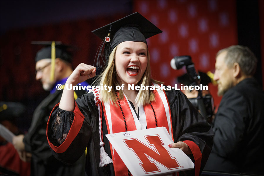 Kaylie Trumble, a Speech-Language Pathologist graduate, shows off her diploma to the Husker Vision cameras Saturday. Winter Undergraduate Commencement in Pinnacle Bank Arena. December 17, 2022. Photo by Craig Chandler / University Communication.